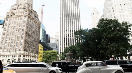 white-retro-car-and-new-limousine-ride-along-the-street-in-new-york_8353-1464